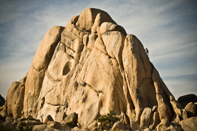 Lone Climber ascending Hidden Valley in Joshua Tree. Photography by Jonathan Costello Photography.
